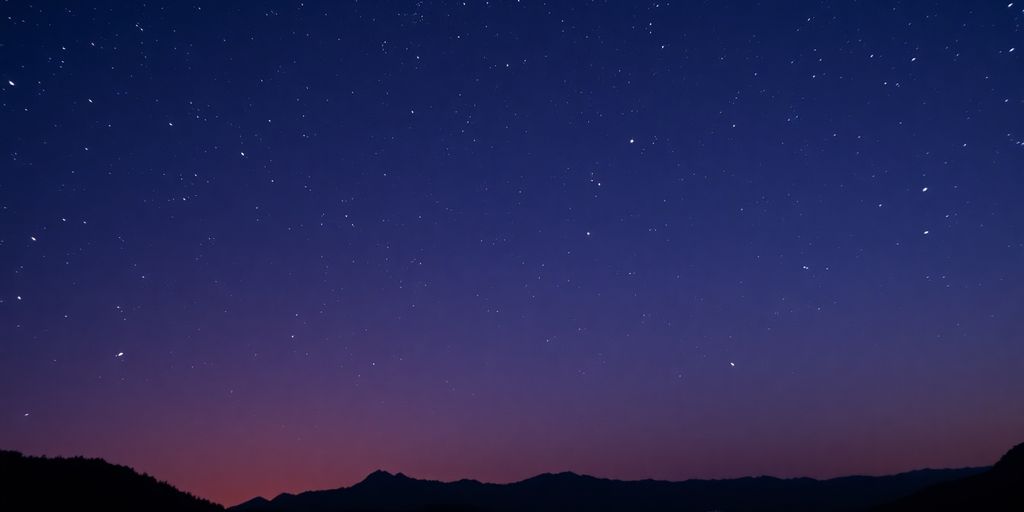 Paisaje celeste con estrellas brillantes y montañas oscuras.